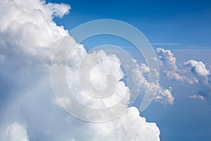 White clouds on blue sky background close up, cumulus clouds high in azure skies, beautiful aerial cloudscape view from above