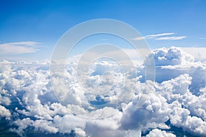 White clouds on blue sky background close up, cumulus clouds high in azure skies, beautiful aerial cloudscape view from above