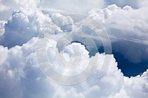 White clouds on blue sky background close up, cumulus clouds high in azure skies, beautiful aerial cloudscape view from above