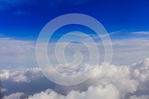 White clouds on a blue sky background. Space for text.