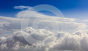 White clouds on a blue sky background. Space for text.