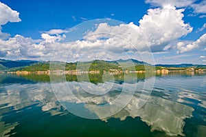 White clouds blue sky beautiful lake with wonderful mirror reflecion