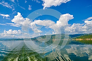 White clouds blue sky beautiful lake with wonderful mirror reflecion