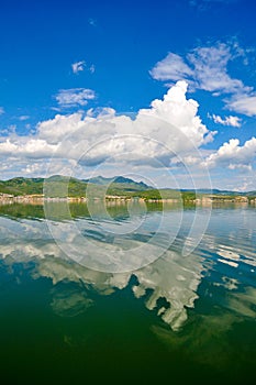 White clouds blue sky beautiful lake with wonderful mirror reflecion