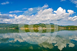 White clouds blue sky beautiful lake with wonderful mirror reflecion