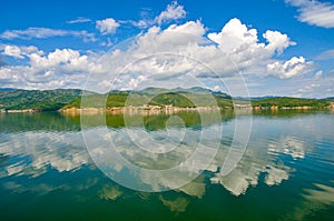 White clouds blue sky beautiful lake with wonderful mirror reflecion