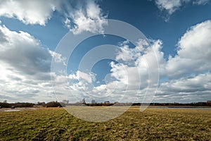 White clouds on blue sky over the meadow