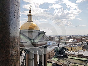White clouds and blue sky over the roofs of the city of St. Petersburg