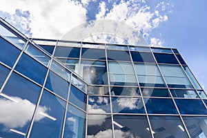 White Clouds and Blue Sky Reflection on Office Building