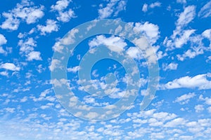 White clouds in bright blue sky as background