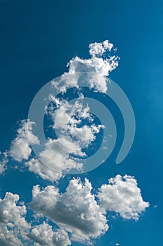 White clouds on clear blue sky background