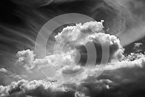 White clouds on a dark dramatic sky. Storm clouds. Black and white sky template