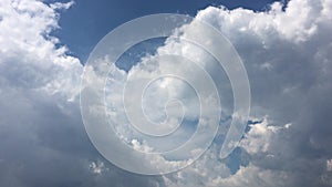 White clouds disappear in the hot sun on blue sky. Motion white clouds blue sky background