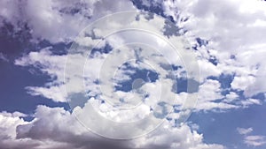 White clouds disappear in the hot sun on blue sky. Motion white clouds blue sky background