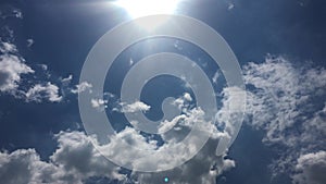 White clouds disappear in the hot sun on blue sky. Time-lapse motion clouds blue sky background. Blue sky. Clouds.