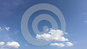 White clouds disappear in the hot sun on blue sky. time-lapse motion clouds, blue sky background and sun