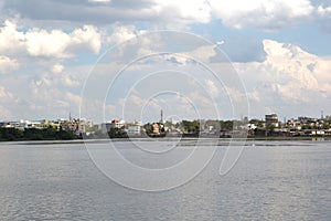 White clouds, lake and houses