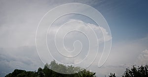 White Clouds motion before the storm on blue sky background. Time Lapse