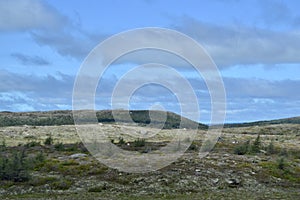 White clouds over rugged landscape along Newfoundland highway