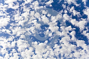 White clouds spread across the blue sky