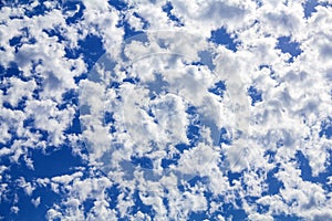 White clouds spread across the blue sky