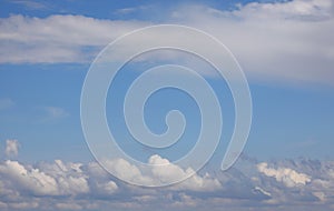 White clouds of various types and sizes layered in the sky