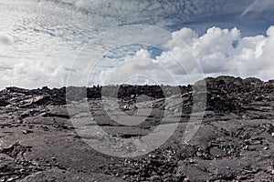 White cloudscape over field of 2018 Kilauea volcano lava, Leilani Estate, Hawaii, USA photo