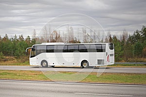 White Coach Bus on Motorway on a Cloudy Day
