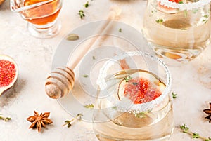 White cocktail with fig, plum, honey and thyme