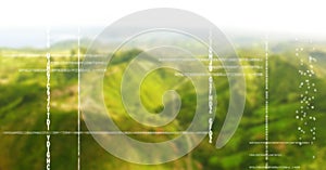 White code against green blurry mountains