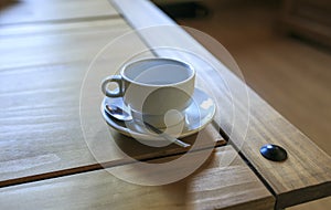 White Cofee cup in a wooden table