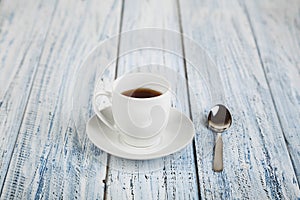 White coffe cup on light wooden background photo