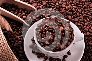 White coffee cup with beans sack and scoop top view