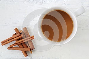 White coffee cup with cinnamon stick