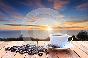 White coffee cup and coffee beans on wood table and view of suns