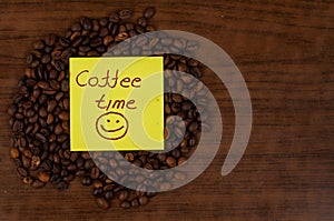 White coffee cup and coffee beans on a wooden table.Coffee time