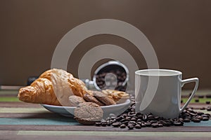 White coffee cup with cookies and beans