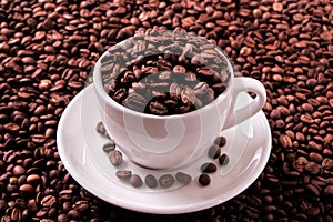 White coffee cup filled with roasted beans