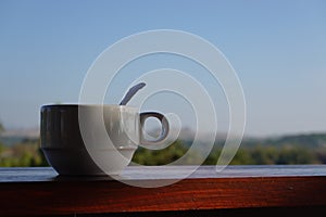 White coffee cup in morning with mountain view, thailand