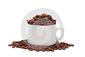 white coffee cup overfilled with roasted coffee beans on white background