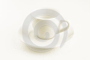 White coffee cup and saucer, empty coffee-free coffee cup, front view from above, or black coffee, on a white background