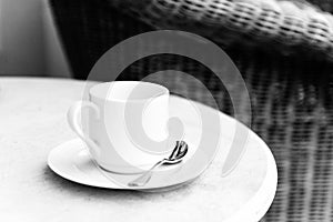 White coffee cup and saucer on a table in a street cafe. Blur, s