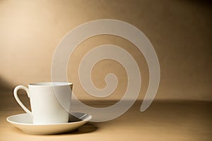 White Coffee Cup and Saucer on Tabletop