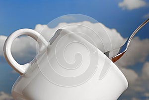 White coffee cup or tea mug over blue sky like a romantic concept