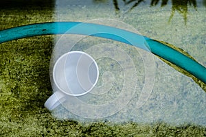 White coffee cup under in water