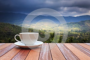 White coffee cup on wood table and view of nature background