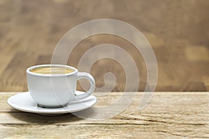 White coffee cup on oak wooden table. Copy space