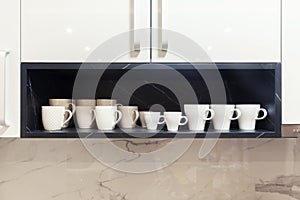 White coffee cups on a wooden shelf