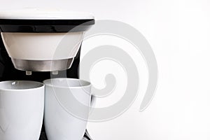 White coffee maker with two mugs on white background