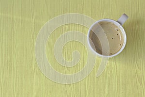 White coffee mug on brown wood background.A cup of white coffee on a wooden table in a restaurant